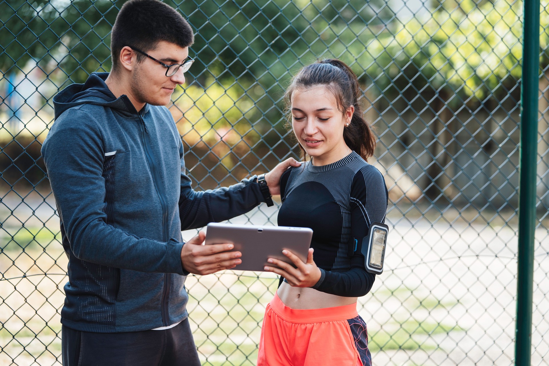 Reassurance gesture shared over workout discussion.